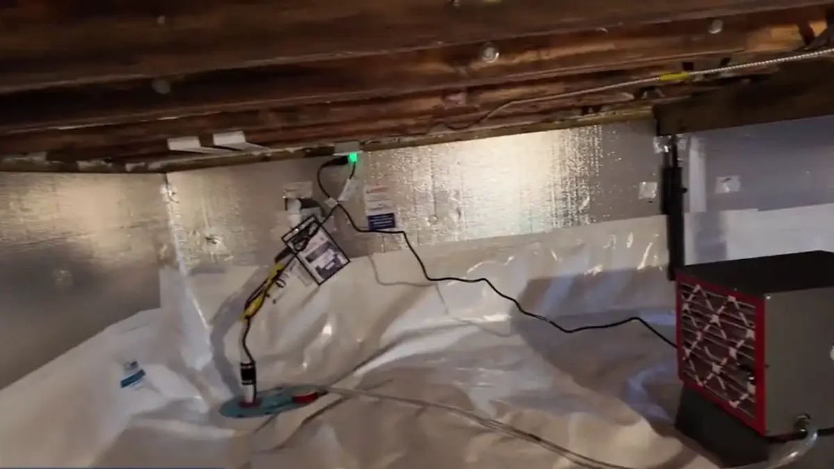Sump pump and dehumidifier on a sealed crawl space liner, an example of crawl space encapsulation in North Carolina