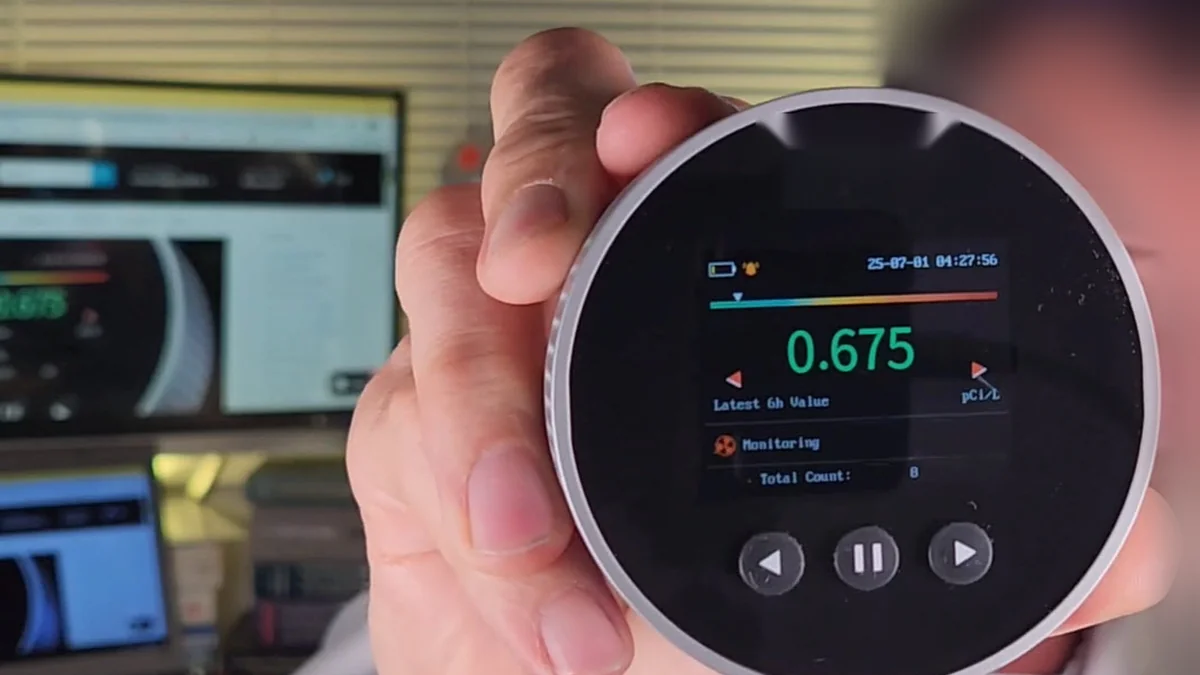 Digital radon monitor showing a reading of 0.675 pCi/L